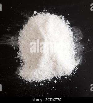 Salt on black Stock Photo