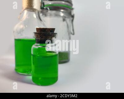 Potions with green liquid. Alchemy set with flasks. small glass bottles with colored liquid for game role play. magic potions with cork stopper for la Stock Photo