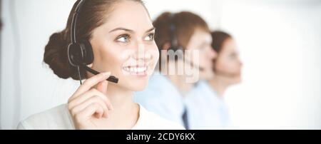Call center. Diverse customer service operators in headsets at work in office. Business concept Stock Photo