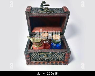 Wood chest with potions blue and red. old treasure casket isolated on white background. Alchemy set with flasks. small glass bottles with colored liqu Stock Photo