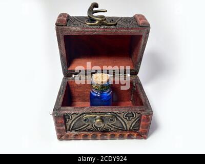 Wood chest with potion blue. old treasure casket isolated on white background. Alchemy set with flasks. small glass bottles with colored liquid for ga Stock Photo