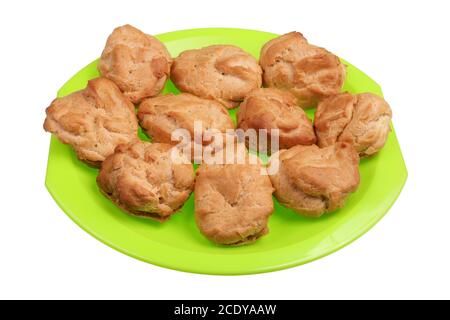Homemade soft sweet eclairs pastries on a green plate isolated Stock Photo