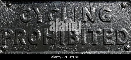 Old painted metal cycling prohibited sign on a park gate Stock Photo