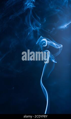 Blue abstract shaped smoke against black background Stock Photo - Alamy