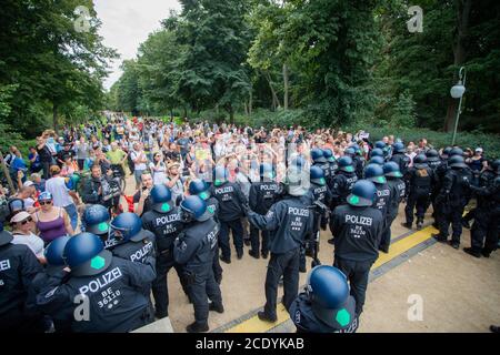 Berlin, Germany. 30th Aug, 2020. Policemen push people into the Tiergarten in a protest against the Corona measures at the Siegessäule. Credit: Christoph Soeder/dpa/Alamy Live News Stock Photo