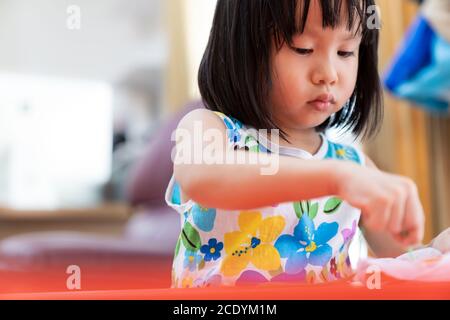 Asian girl home schooling sewing Stock Photo