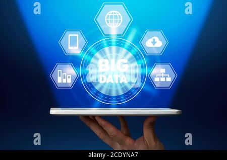 Big Data Digital Hologram With Multimedia Icons Over Digital Tablet In Male Hand Stock Photo