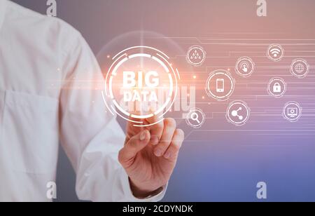 Businessman selecting and pressing Big Data virtual icon button on digital screen Stock Photo