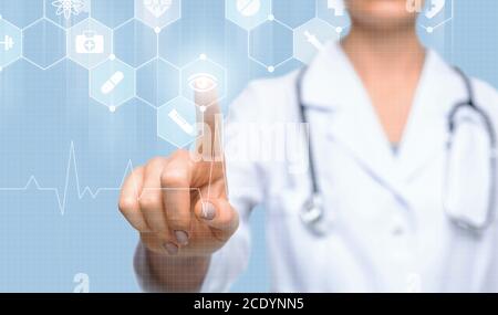 Innovative Medicine. Female doctor pressing button on digital screen with medical icons Stock Photo