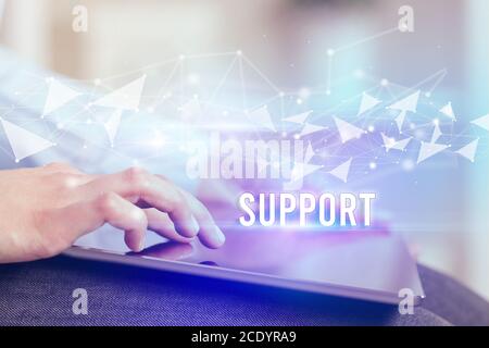 Close up hands using tablet with SUPPORT inscription, modern business technology concept