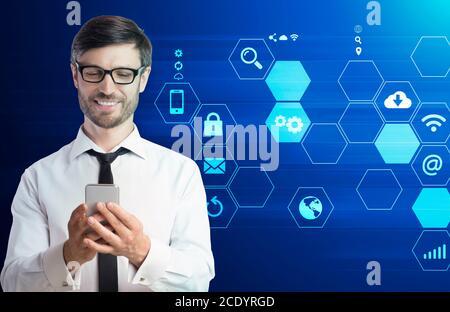 IOT Concept. Businessman using smartphone over social media icons set on background Stock Photo