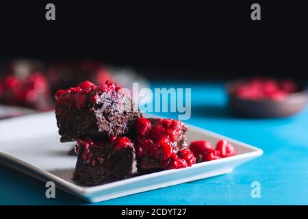 Closeup view of gluten free home made raspberry brownie over blue vintage wooden table Stock Photo