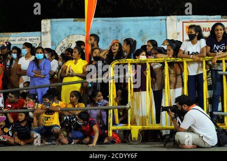 Colombo, Sri Lanka. 29th Aug, 2020. People watch the performance during an annual Buddhist procession at Kotte Rajamaha Viharaya, a historic Buddhist temple in Colombo, Sri Lanka, Aug. 29, 2020. The procession consists of traditional local dances and various cultural dances, in addition to the elephants that are usually adorned with lavish garments. Credit: Tang Lu/Xinhua/Alamy Live News Stock Photo