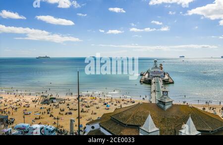 Bournemouth, UK. Sunday 30 August 2020. Bournemouth beach is busy on the August Bank Holiday weekend as people flock to the beach in the sunny weather. Seen from an aerial view. Credit: Thomas Faull/Alamy Live News Stock Photo