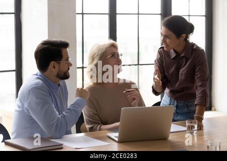 Diverse business people discussing online project in office. Stock Photo