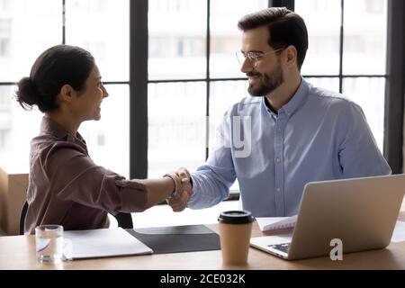 Diverse young business people making agreement in office. Stock Photo