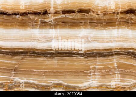 Beige patterned onyx close-up, natural stone backgorund. Stock Photo
