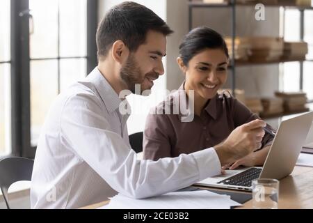 Smiling young mixed race managers working on online project. Stock Photo