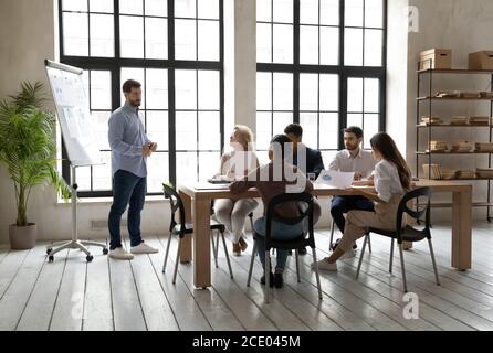 Skilled young speaker presenting corporate marketing strategy. Stock Photo