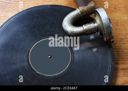 A rusty vintage vinil player  plays an old shabby dusty gramophone record disc Stock Photo