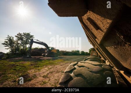 Heavy truck and excavator on construction site Stock Photo