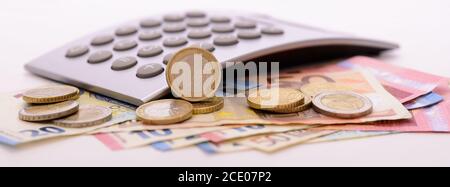 heap of banknotes of Euo currency with coins and calculator Stock Photo