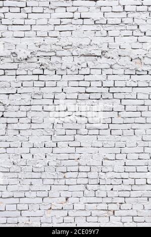 rough white brick wall with leaking plaster background Stock Photo