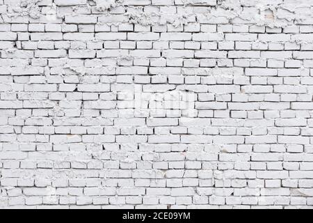 rough white brick wall with leaking plaster background Stock Photo