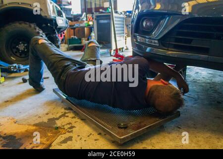 Car mechanic at work in repair garage Stock Photo