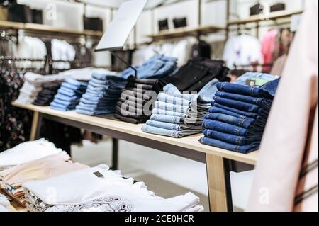 Clothes, jeans on shelf in clothing store, nobody Stock Photo