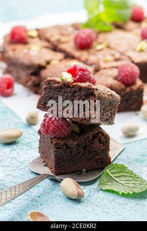 Brownie slices with raspberries and pistachios.