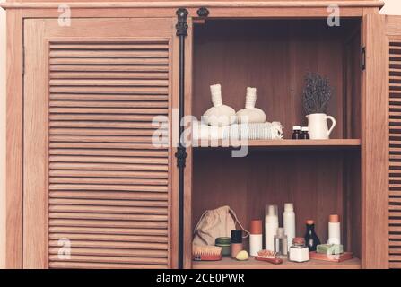 Bath accessories on shelves in bathroom Stock Photo