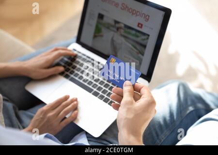 Above close up view young consumers enjoying shopping online. Stock Photo