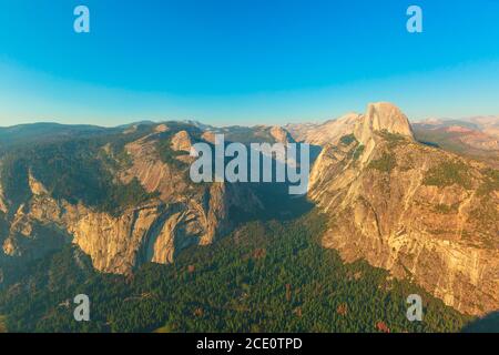 Washburn Point sunset panorama in Yosemite National Park, California, United States. View of Half Dome, Liberty Cap, Yosemite Valley, Vernal Fall, and Stock Photo