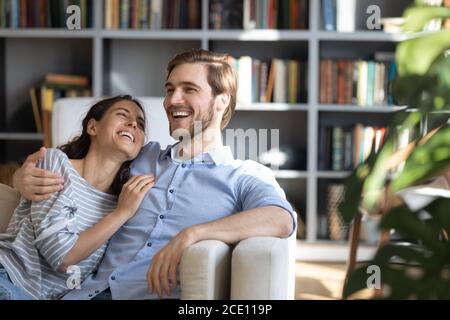 Overjoyed young couple having fun at home. Stock Photo