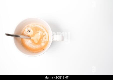 A hot fresh cup of coffee with a nice layer of coffee cream with a white background. home made coffee. Stock Photo