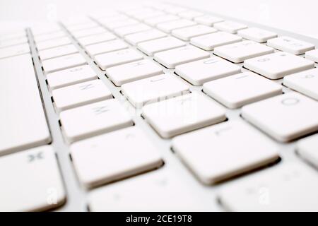 closeup picture of a white keyboard from a low perspective giving a long view, great for business background. Stock Photo