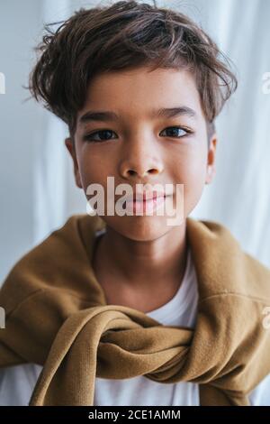 Portrait of a happy indian asian kid. Long sleeve tied on his shoulders. Stock Photo