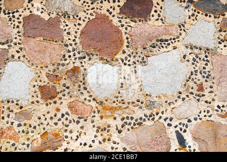 Handmade stone wall texture. Colorful medieval castle wall background. Beige rock facade surface Stock Photo