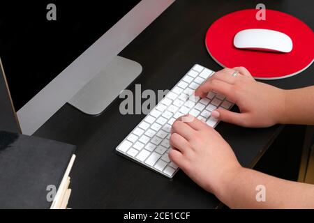 Close up of hands typing keyboard and using mouse at the office. Concept of education and working on computer. Stock Photo