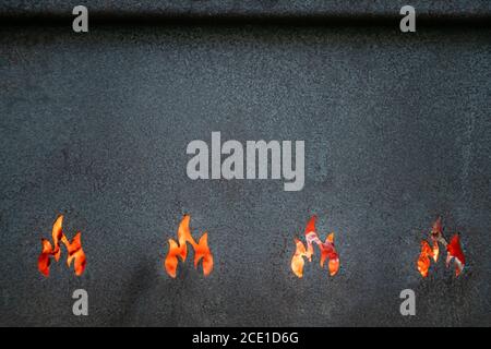 Closeup view of metal barbeque grill texture. Red hot flames background. Nobody. Space for text. Stock Photo