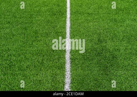 Green synthetic grass sports field with white line shot from above. Soccer, rugby, football, baseball sport concept Stock Photo