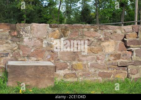 The old stone wall has a a big crack in the foundation. Stock Photo