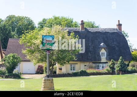 Thatched cottage and village sign, The Green, Biddenham, Bedfordshire, England, United Kingdom Stock Photo