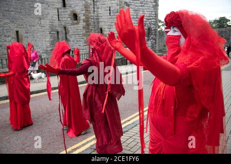 Caernarfon Castle, Wales, UK. 30 August 2020, Extinction Rebellion Protestors and Red Rebel Brigade take over Caernarfon Castle to protest about climate change and global warming. Children's shoes signify that it is the children that will suffer in the future. Credit: Denise Laura Baker/Alamy Live News Stock Photo