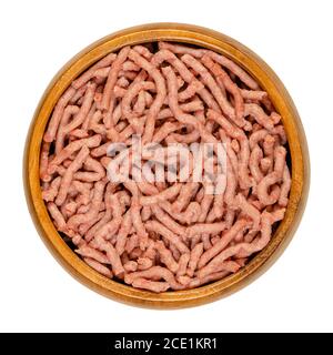 Vegan ground meat in a wooden bowl. Substitute for minced meat based on pea protein, driven through the meat grinder. Meat alternative. Close-up. Stock Photo