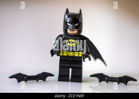 Timisoara, Romania - April 12, 2020: Close-up of small toy figurine. Batman with two batarangs on the ground. Stock Photo