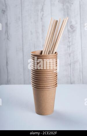 Biodegradable cups and drinking straws on light grey background Stock Photo