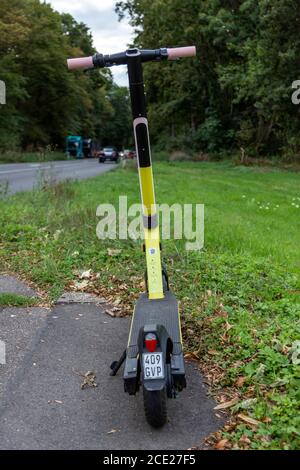 Cologne, NRW, Germany, 08 29 2020, parked street scooter to rent on a sidewalk of a country road Stock Photo