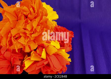 Orange flowers made out crepe paper, used in the festivity of dia de los muertos in Latin America Stock Photo
